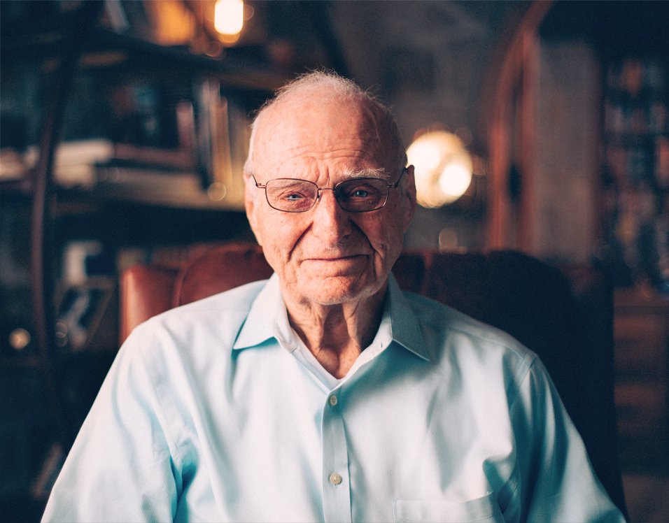 Tom Paterson in later life, seated in a book-lined study